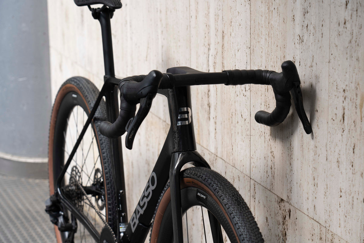 Front-end view of the integrated carbon gravel cockpit and Campagnolo shifter levers on the Basso Palta III Carbon Chrome complete bicycle by Cicli Corsa.