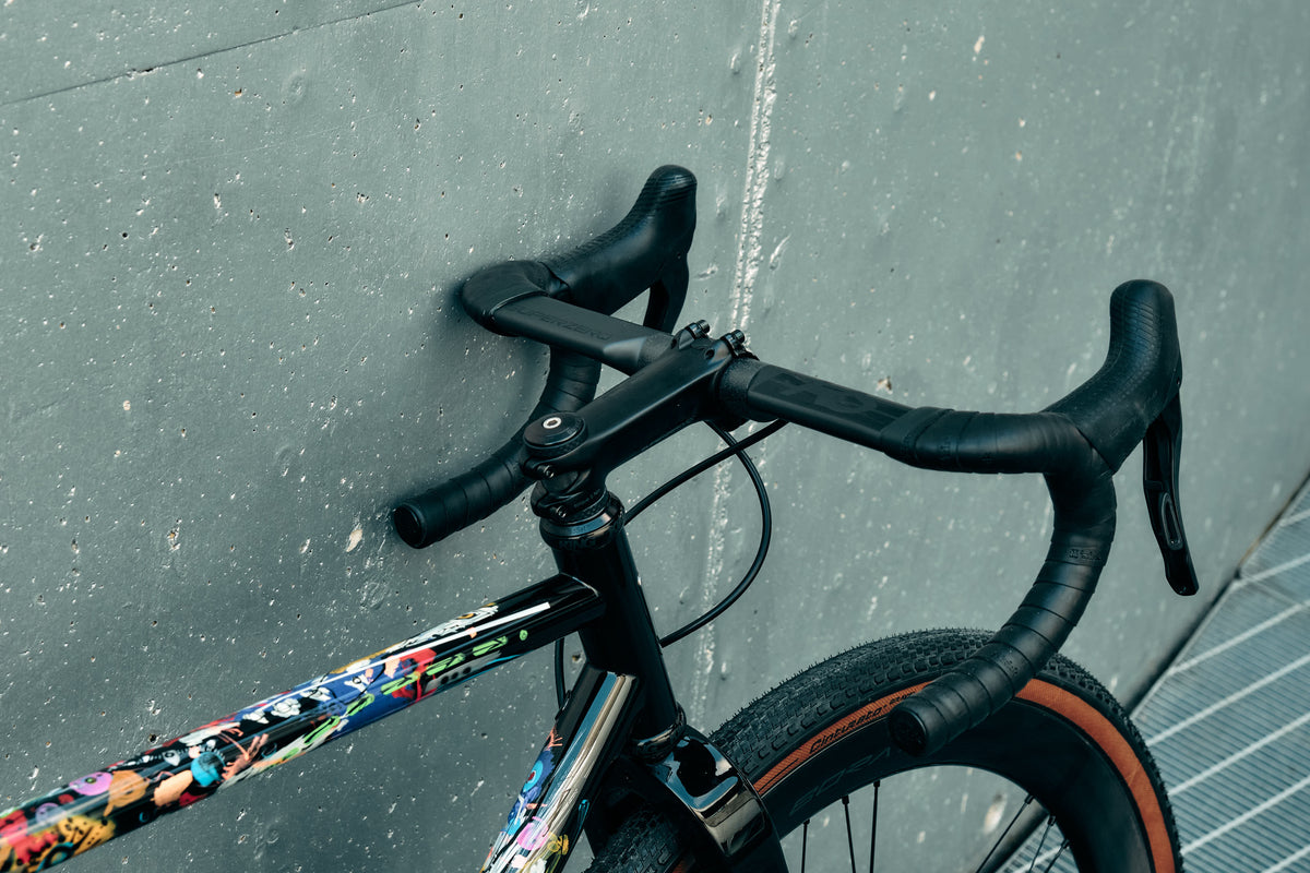 Close-up of the Deda handlebar and stem cockpit setup on the bespoke Dario Pegoretti Duende AR complete bicycle by Cicli Corsa.
