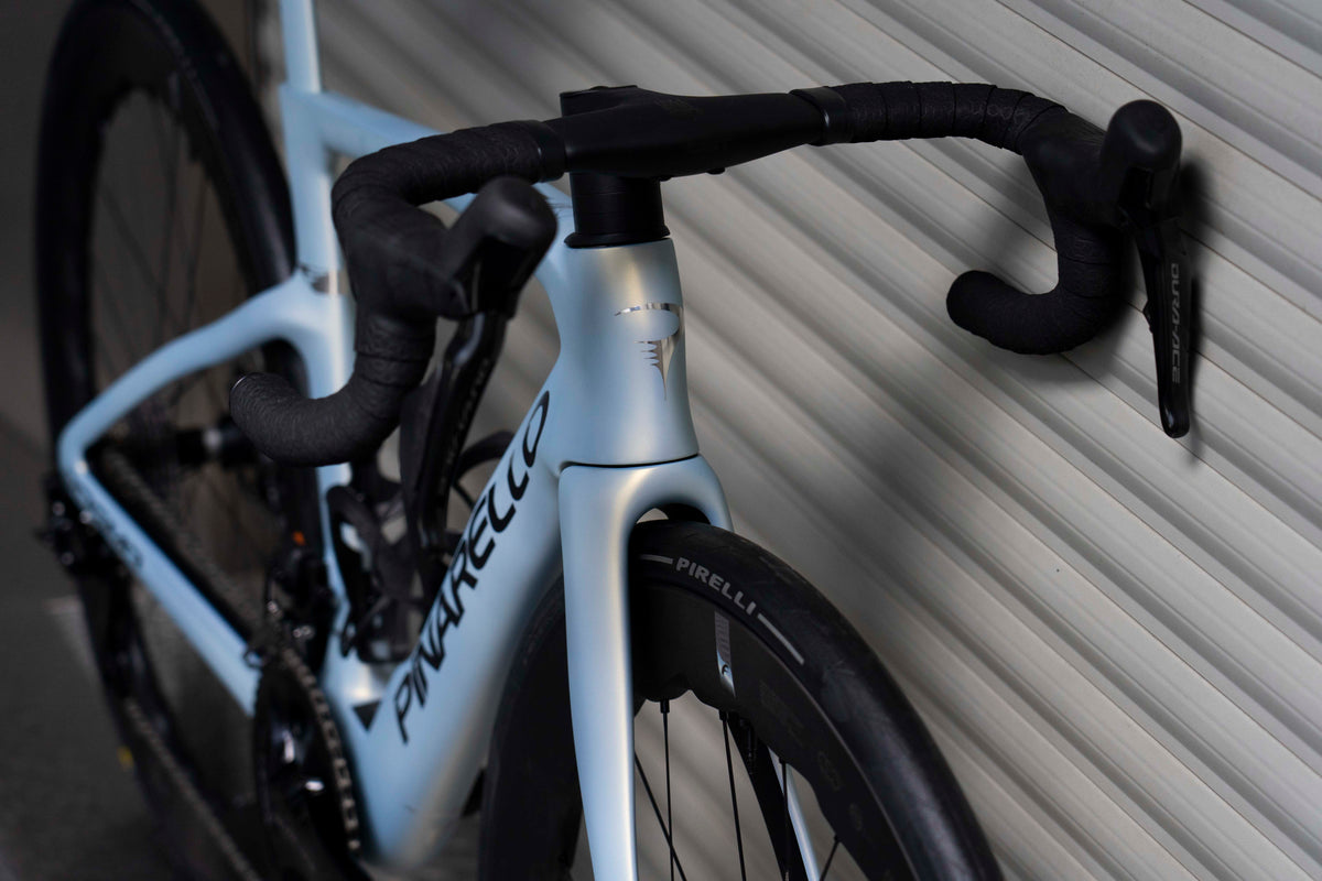 Front-end view of the integrated MOST carbon handlebar and Shimano Dura-Ace Di2 levers on the Pinarello Dogma F complete bicycle by Cicli Corsa.